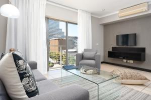 a living room with a couch and a glass table at Icon Luxury Apartments in Cape Town +103 photos