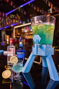 a drink in a blender sitting on a table with a glass at Crowne Plaza Huizhou, an IHG Hotel in Huizhou