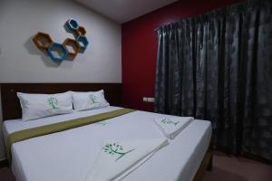 Postel nebo postele na pokoji v ubytování The Ideal Nest Kumbakonam
