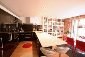 a kitchen with a table and chairs in a room at Go Donosti Jane in Donostia-San Sebastián +7 photos