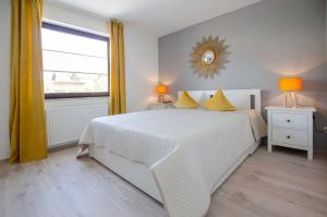 een slaapkamer met een wit bed en een raam bij Ferienwohnung Clara in Bad Sachsa