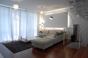 a living room with a white couch and a chair at Go Donosti Villa Buda in San Sebastián