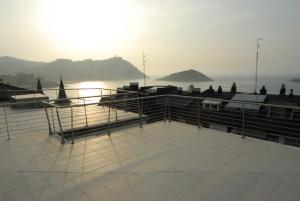 a boat deck with a view of the water at Go Donosti Villa Buda in San Sebastián