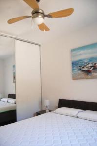 a bedroom with a ceiling fan and a bed at Status-M Apartments 85 in Bečići +28 photos