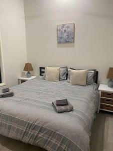 a bedroom with a bed with two pillows on it at Rural Self Contained 3 bedroom Cottage on acreage, in Landsborough