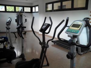 a gym with cardio machines and a scale on a treadmill at Apartamentos Tamarindo Cala de Finestrat in Cala de Finestrat