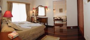 a hotel room with a bed and a mirror at Ocean Gardens in Funchal