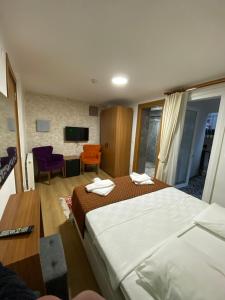 Habitación de hotel con 2 camas y TV en Masal Hotel, en Büyükada