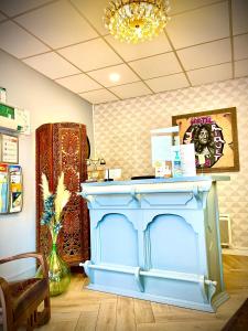 a blue counter in a room with a table at Hôtel Paul Riquet in Béziers