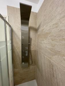 una doccia con una porta in vetro in un bagno di SOAVE GUEST HOUSE a Soave