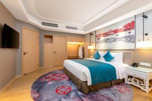 Rúm í herbergi á voco Guangzhou Shifu by IHG