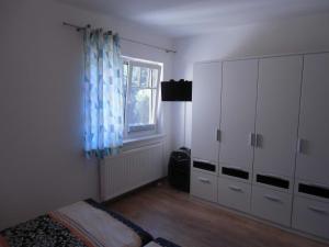 1 dormitorio con armarios blancos y ventana en Bansiner Seeperle, en Bansin