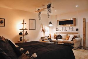 a living room with a bed and a couch at Smart-Apartment BlickWinkel Schwarzwald in Gaggenau