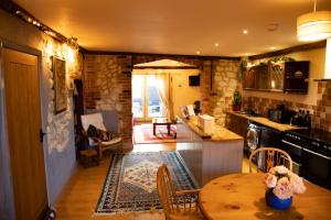 a kitchen with a table and a dining room at Old Barn, Beach Farm Hunstanton - Dog Friendly in Heacham