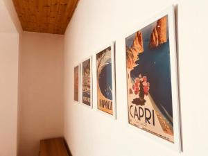 four posters on the wall of a room at Villa Regina in Torre San Patrizio