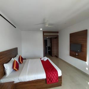 A bed or beds in a room at JB Residency
