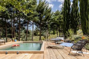 a swimming pool on a wooden deck with trees at Dominio Vale Flores in Advagar