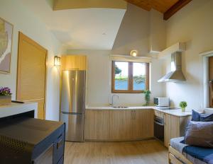 a kitchen with a stainless steel refrigerator and a sink at Casa Busto in Valdoviño +23 photos