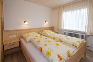 a bedroom with a bed and a window at Ferienwohnung Plenk inkl. Chiemgaukarte in Ruhpolding