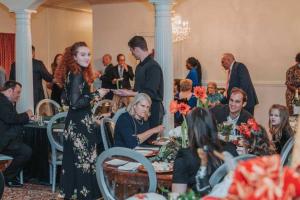 a group of people sitting at tables in a room at The 1425 Inn in Columbia