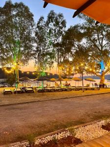 a group of tables and umbrellas in a park at Marimare Beach & Bungalow in Marmaris