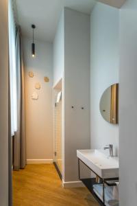a bathroom with a sink and a mirror at FINCH - boutique hotel in Deventer