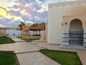 a building with a deck on the side of it at Coral Reefs Hotel Dahab in Dahab