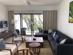 a living room with a couch and a table at Rose des Sables in Belle Mare