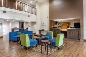 a waiting room at a hospital with blue and green chairs at Comfort Suites Southpark in Colonial Heights