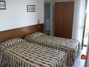 Posteľ alebo postele v izbe v ubytovaní HOTEL SANTOROTTO di FABIO TERROSI