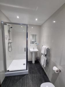 a bathroom with a shower and a sink at Premier Lodge in Falkirk