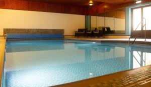 a large swimming pool in a hotel room at Balavil Hotel in Newtonmore