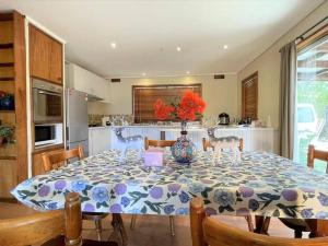 a kitchen with a table with a vase on it at Apollo bay Holiday House in Apollo Bay