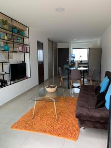 a living room with a glass table and a couch at Nerea-Casa de Playa en Condominio Mar Adentro in Naranjalito