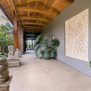 a hallway with plants and a large painting on the wall at Forest Nature Spa in The Crags