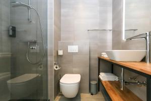 a bathroom with a sink and a toilet and a shower at Fletcher Hotel Rotterdam-Airport in Rotterdam