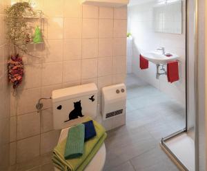 a bathroom with a toilet with a dog head on it at BnB "A la Crus" in Crana +42 photos