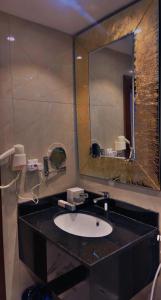 a bathroom with a sink and a mirror at فندق ايون الندى Ion Hotel in Riyadh +26 photos