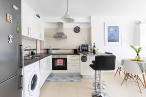 A kitchen or kitchenette at Home2Book Stunning Apartment Bajamar