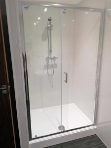 a shower with a glass door in a bathroom at Premier Lodge in Falkirk