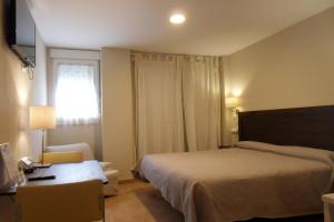 Posteľ alebo postele v izbe v ubytovaní Hostal El Estudio