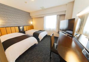 Postel nebo postele na pokoji v ubytování APA Hotel Aomori Eki Kenchodori