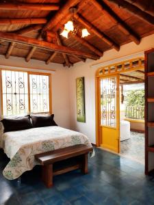 a bedroom with a bed and a wooden ceiling at FINCA HOTEL DON JULIO in Santa Rosa de Cabal