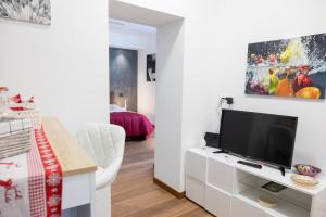 a living room with a flat screen tv on a white cabinet at Eutuxia in Taranto