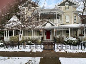 a house with a red door in the snow at The 1425 Inn in Columbia