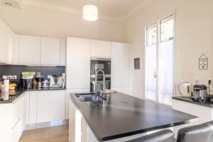 A kitchen or kitchenette at Spacious and Bright House with heated Pool