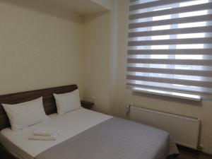 Postel nebo postele na pokoji v ubytování Prometey Hotel