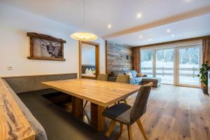 a living room with a wooden table and a couch at Schönachhof in Gerlos