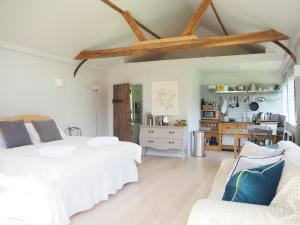 a bedroom with two beds and a living room at The Fisherman's Lodge in Andover