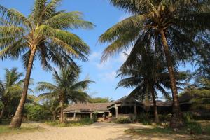 una casa sulla spiaggia con palme di Lazy Beach a Koh Rong Sanloem
